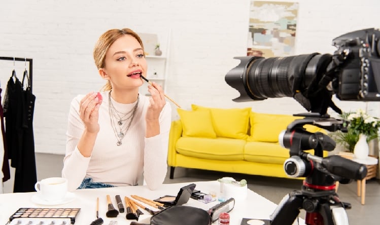 A YouTuber doing make up while getting recorded.
