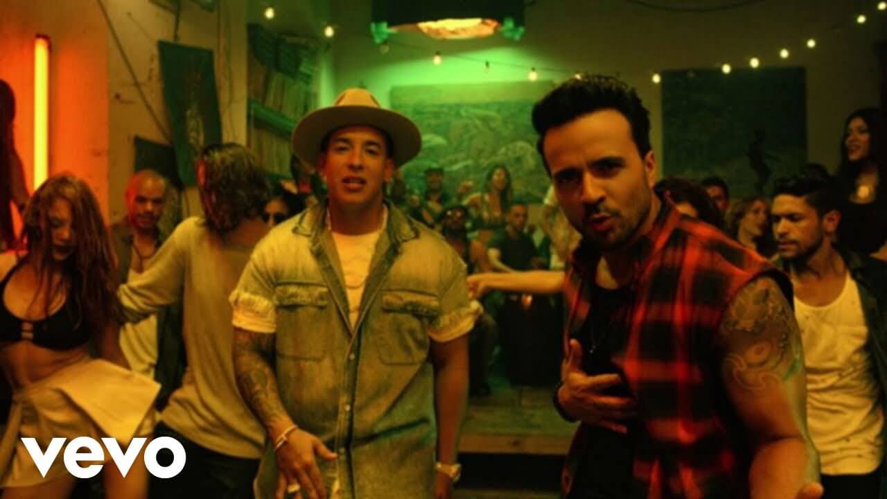 despacito music video with two singers and many other dancers in the back ground
