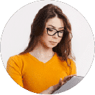 a woman with yellow shirt, glasses and long brown hair with her tablet in her hand