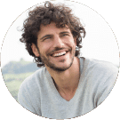 a young man with white shirt and curly short hair