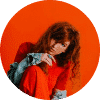 a girl with red sweatshirt and orange background