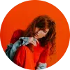 a girl with red sweatshirt and orange background